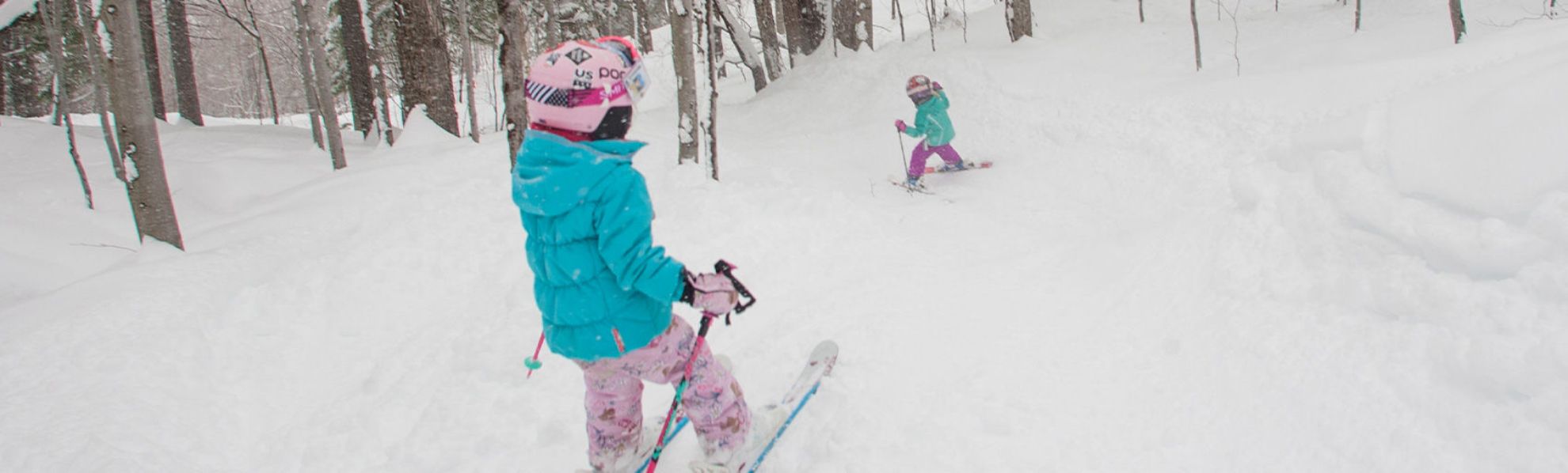 Kids skiing in glades.